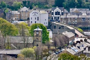 Looking down on a village with church, bridge and hotel