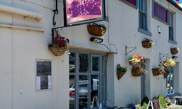 White pub with picnic tables