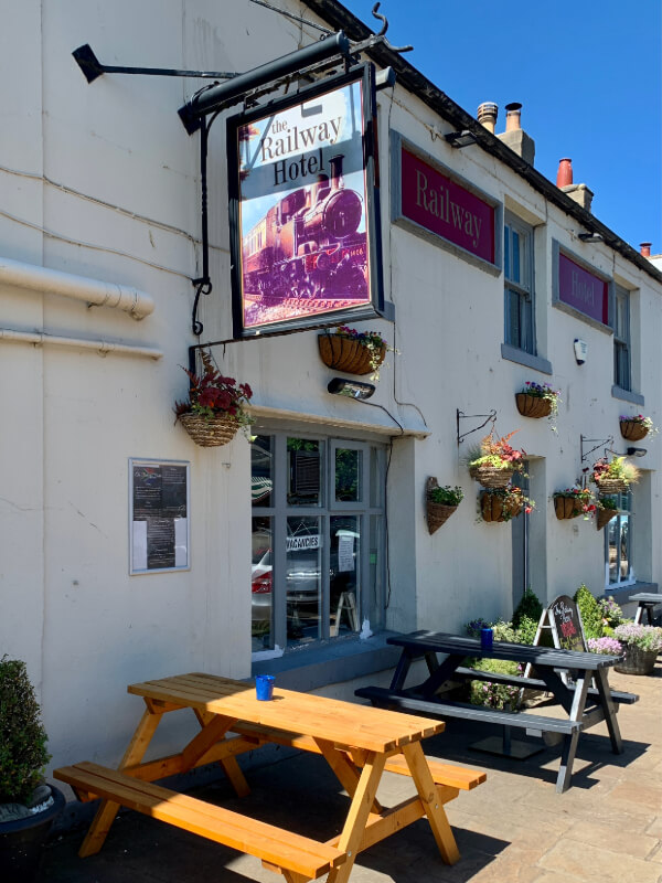 White pub with picnic tables