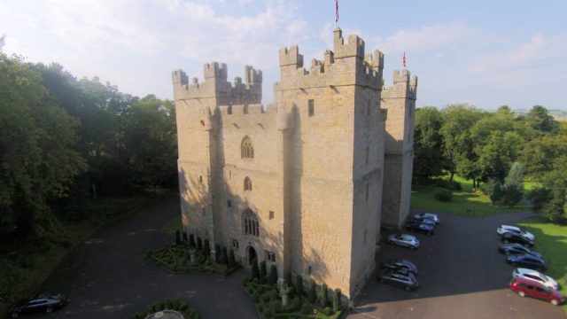 Aerial view of castle tower and parked cars
