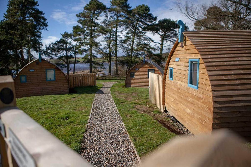 Wooden buildings next to a lake