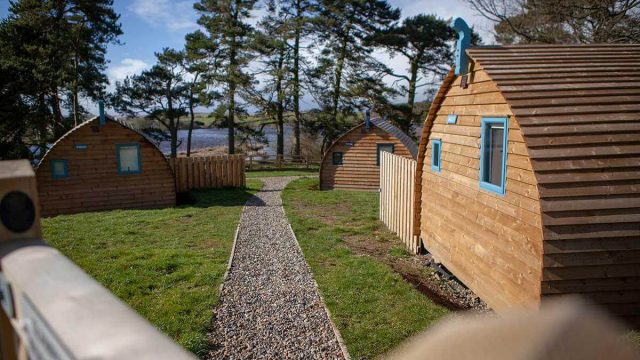 Wooden buildings next to a lake