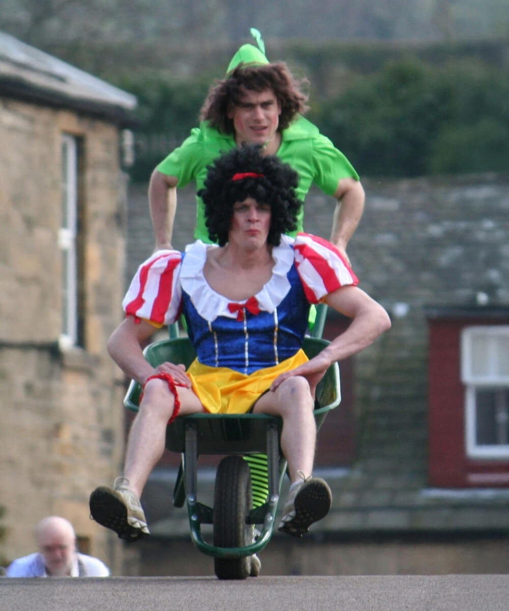 Fancy dress wheelbarrow race competitors