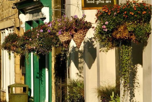Shop fronts with hanging baskets