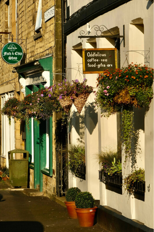 Shop fronts with hanging baskets