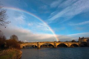 A rainbow over a bridge