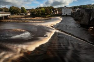 River weir with blurred water